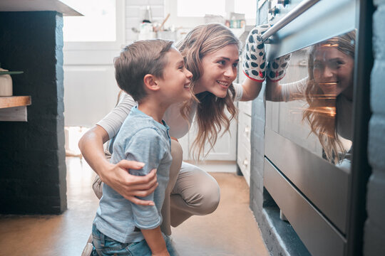 Mother, baking and boy or house oven, child development and helping in kitchen together with dessert or cookies. Happiness, childhood and fun activity with stove, teaching and bonding in apartment