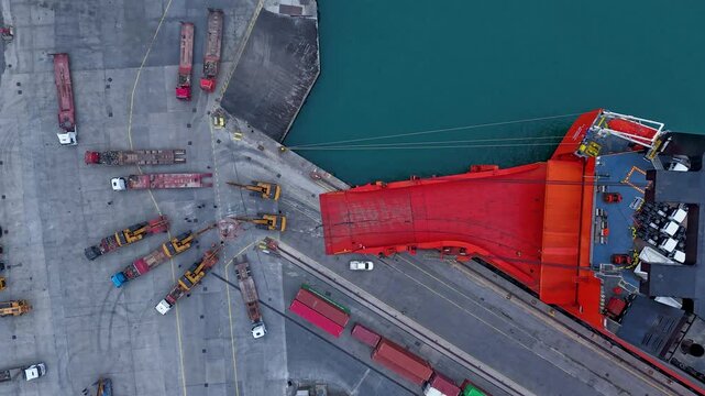 4K time lapse shot with a drone while unloading the ship cargo to the customs section at the port