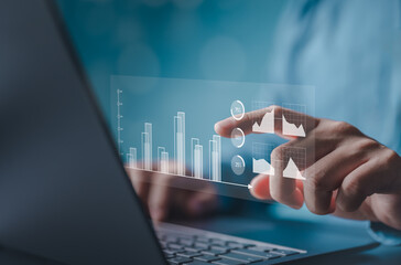 Finance and return on investment concept. Man touching on a virtual screen of data and charts, investments analysis in assets and financial growth graphs, business strategy analysis, and marketing.