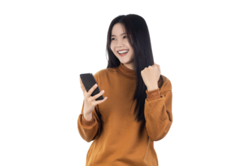 ํYoung Asian woman holding smartphone with fists clenched celebrating victory expressing success isolated on white background with clipping path.