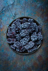 freshly frozen, blackberries on a plate, top view, no people,