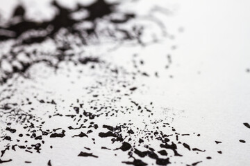 Extreme close up of black acrylic paint texture on paper. Selective focus.