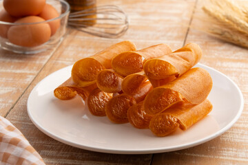 Crispy Mini Pancake Rolls stuffed with condensed milk and butter in white plate.Thai snack.(Khanom Tokyo or Khanom Tokiao)