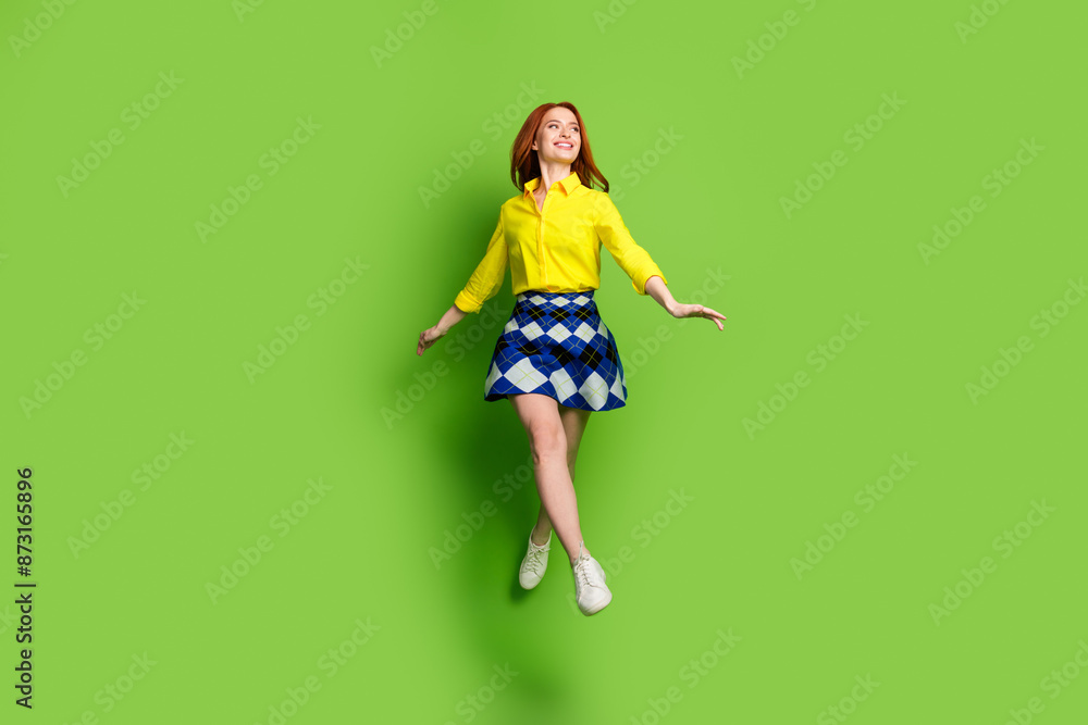 Canvas Prints Full length photo of lovely young lady look empty space jump dressed stylish yellow garment isolated on green color background