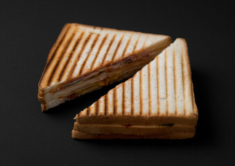 club sandwich on a wooden board on a dark background