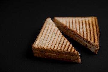 club sandwich on a wooden board on a dark background