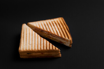 club sandwich on a wooden board on a dark background