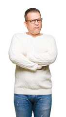 Fototapeta premium Middle age arab man wearing glasses over isolated background skeptic and nervous, disapproving expression on face with crossed arms. Negative person.