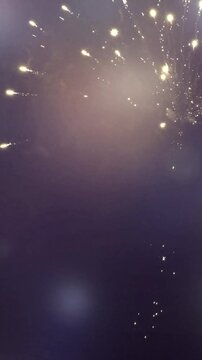 golden firworks isolated on empty blurred night sky, loopable decoration element for festive holiday celebration background with copy space