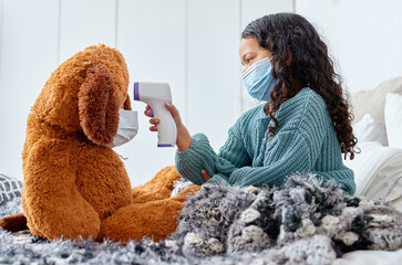 Health, teddy bear and child with thermometer on bed for virus prevention, safety or fever in...