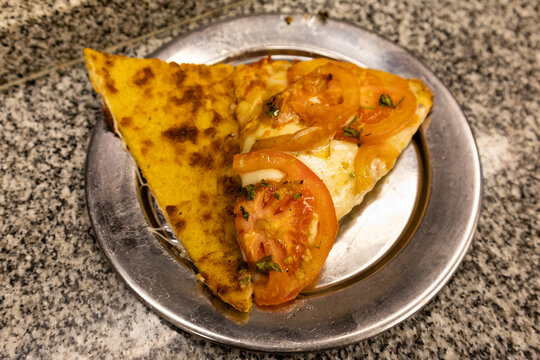 Argentinian Pizza with Faina on a Metal Plate
