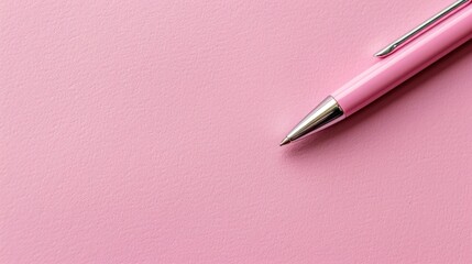 Top view of pen on empty pink paper with space for writing