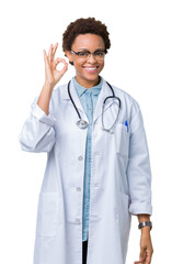 Fototapeta premium Young african american doctor woman wearing medical coat over isolated background smiling positive doing ok sign with hand and fingers. Successful expression.