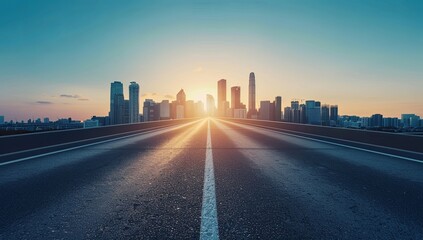 Fototapeta premium Long Asphalt Road Leading to the Horizon with City Skyline in the Background, Blue Sky and Golden Sunlight, Abstract Wide Highway Background, Perfect for Travel, Journey, and Business Trip Concepts