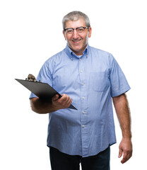 Handsome senior inspector man holding clipboard over isolated background with a happy face standing...