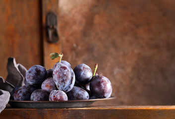 fresh organic plums on wooden table