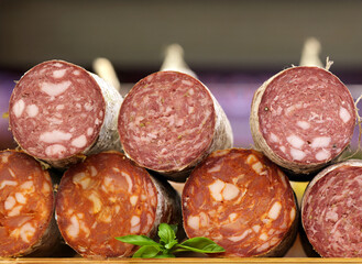 sausage loaf in packaging on a wooden board