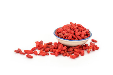 Pile of Dried goji berries and in a ceramic plate isolated on white background.