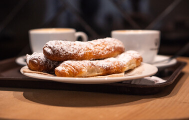 Indulging in coffee and pastries at a cozy cafe