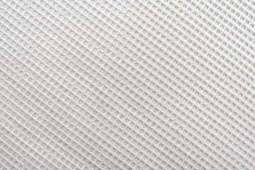 Texture of a white mesh silicone mat. Silicone material background. Net