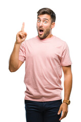 Naklejka premium Young handsome man over isolated background pointing finger up with successful idea. Exited and happy. Number one.