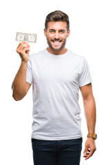 Young handsome man holding dollars over isolated background with a happy face standing and smiling with a confident smile showing teeth