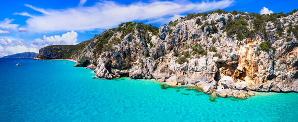 most beautiful beaches of Sardegna island (Italy) - Cala Luna in gulf of Orosei .  Aerial panoramic drone view of white sandy beach, caves and turquoise sea © Freesurf