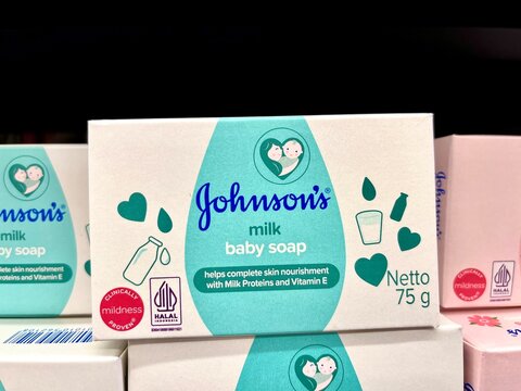 Jakarta, Indonesia - July 1st, 2024 - Johnson's baby milk soap bar 75 gram product packaging isolated on horizontal ratio store shelf background.