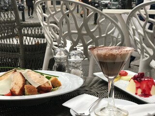 Outdoor dining with gourmet meal and chocolate drink