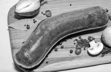 Tasty sausages and vegetables isolated over solid background. Black and white monochrome photo