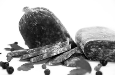 Tasty sausages and vegetables isolated over solid background. Black and white monochrome photo