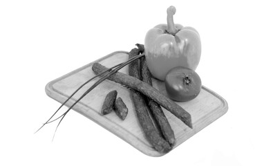 Tasty sausages and vegetables isolated over white background. Black and white grayscale photo background