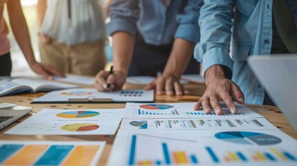 Fototapeta premium A business team of colleagues meets to plan, strategize, analyze, and discuss new financial graph data in the office.