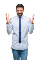 Fototapeta premium Adult hispanic business man over isolated background celebrating mad and crazy for success with arms raised and closed eyes screaming excited. Winner concept