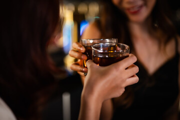 Two women at a nightclub Drink alcohol, talk, party, dance together happily.