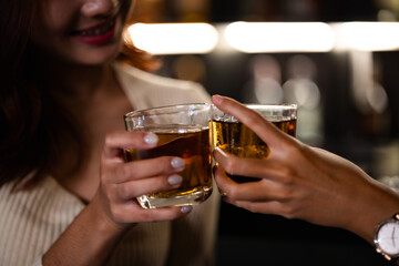 Two women at a nightclub Drink alcohol, talk, party, dance together happily.