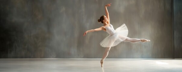 A ballerina, clad in a white tutu, is captured mid-leap in a ballet performance, embodying the beauty and athleticism of dance in a studio with artistic lighting.