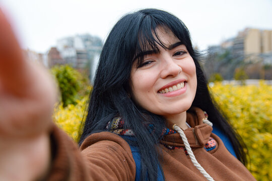 happy Woman taking selfie Photo holding phone with her hand