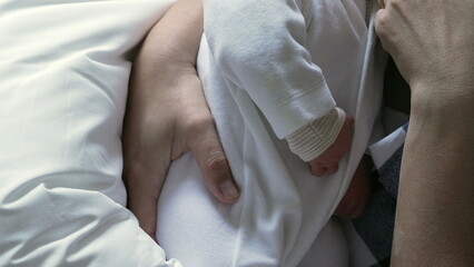 Close-up of mother breastfeeding her newborn baby, emphasizing the intimate and nurturing moment of maternal care and bonding in a calm home environment