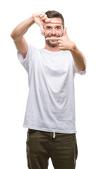 Fototapeta premium Young handsome man over isolated background smiling making frame with hands and fingers with happy face. Creativity and photography concept.
