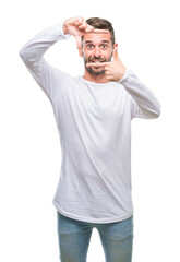 Fototapeta premium Young handsome man over isolated background smiling making frame with hands and fingers with happy face. Creativity and photography concept.