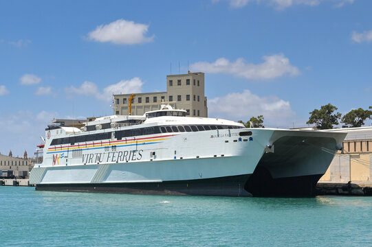 Valletta, Malta - 6 August 2023: Fast catamaran car ferry Jean de la Vallette operated by Virtu Express moored in the port of Valletta.