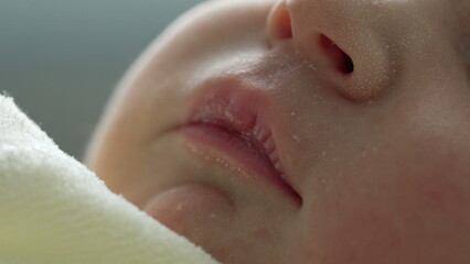 Macro shot of a newborn's face, focusing on the delicate skin, closed eyes, and peaceful expression. pure innocence and tranquility of a newborn's peaceful sleep