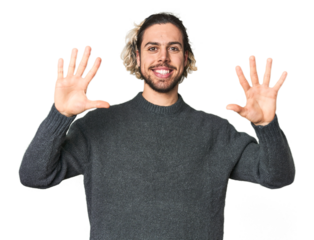 Young Caucasian man in studio setting showing number ten with hands.