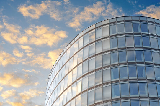 Office building  block with rounded corners in Brussels under a blue sky with fluffy clouds
