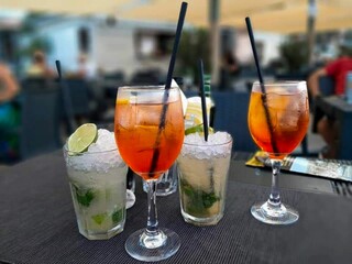 Coastal Cheers A Relaxing Evening by the Sea, A tranquil coastal evening with cheers and drinks by the sea, surrounded by golden hour serenity.