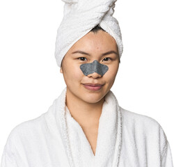 Chinese woman in robe with pore strip on nose in studio