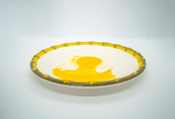 A fried poached egg with yellow poached egg on a plate ready to eat delicious