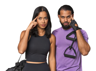 Young Latino couple ready for gym training pointing temple with finger, thinking, focused on a task.
