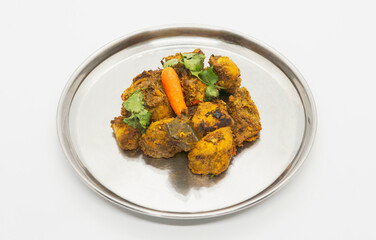 A Plate of Curry Chicken, Fried Spicy Nepali Style Chicken Indian Chicken Dish served on a plate with chilli 
